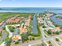 An aerial view shows waterfront townhomes with boat docks, surrounded by waterways and lush greenery at 4306 Sunray Ct, Tampa, FL 33615