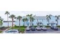 Light blue condo building with parking, palm trees, and waterfront views at 5129 Se Salmon Se Dr # A, St Petersburg, FL 33705