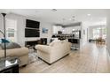 Spacious living room with tile floors, modern furniture, and an open floor plan leading to the kitchen at 5501 N 15Th St, Tampa, FL 33610