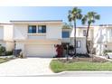 Charming two-story home with a well-manicured lawn and a two-car garage at 5559 Escondida S Blvd, St Petersburg, FL 33715
