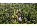 A birds-eye view of the property with a garage and wooded land, set in a beautiful neighborhood at 9298 Carr Rd, Riverview, FL 33569