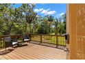Relax on this spacious deck with wooded views and wicker furniture; a perfect outdoor retreat at 9298 Carr Rd, Riverview, FL 33569