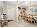 Inviting entryway leading into the dining room with elegant decor, including ornate chairs and a decorative chandelier at 11818 Valhalla Woods Dr, Riverview, FL 33579