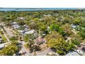 Aerial view of the house nestled within a lush, green neighborhood near the water at 1232 Sedeeva S Cir, Clearwater, FL 33755