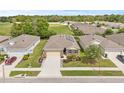 Aerial view of the home showcasing its location in a well-planned neighborhood with lush landscaping at 13675 Paddington Way, Spring Hill, FL 34609
