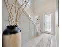 Bright entryway featuring a decorative vase, staircase, and tile flooring at 1476 Fort Cobb Ter, Wesley Chapel, FL 33543