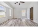 Bright, airy bedroom featuring sleek wood-look flooring and a modern ceiling fan at 1524 Marsh Wood Dr, Seffner, FL 33584