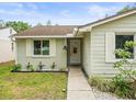 Charming home exterior showcasing well-maintained landscaping and a welcoming front entrance at 16116 Manorwood Cir, Tampa, FL 33624