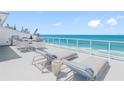 A stunning balcony features lounge chairs, a dining set, and an ocean view at 19816 Gulf Blvd # 602, Indian Shores, FL 33785