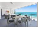 An ample covered balcony with an outdoor dining set and seating area overlooks the ocean at 19816 Gulf Blvd # 602, Indian Shores, FL 33785