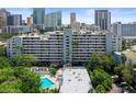 Exterior shows the building, palm trees and the pool for the community at 201 W Laurel St # 307, Tampa, FL 33602