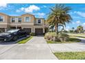 Exterior view of a tan two-story townhome with a front yard and a two-car garage at 2227 Golden Falcon Dr, Ruskin, FL 33570