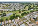 Stunning aerial view of the property, nestled within a vibrant community with golf courses and scenic ponds at 336 Northway Dr, Sun City Center, FL 33573