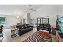 Bright living room featuring tile floors, ceiling fan, and large windows that flood the space with natural light at 336 Northway Dr, Sun City Center, FL 33573