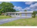 Charming single-story home features a two-car garage, brick accents, and a long driveway with a unique compass design at 39407 Rockford Ave, Zephyrhills, FL 33542