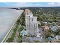 Breathtaking aerial view of a coastal high-rise building, highlighting its prime location near the beach and city at 4141 Bayshore Blvd # 306, Tampa, FL 33611