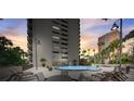 Relaxing pool area with lounge chairs, tables, and palm trees, offering a perfect outdoor retreat in a luxurious setting at 4141 Bayshore Blvd # 306, Tampa, FL 33611
