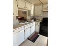 Functional kitchen features white cabinets, essential appliances, and a practical layout at 4217 Tamargo Dr # A, New Port Richey, FL 34652