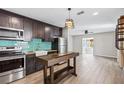 Bright kitchen with stainless steel appliances, wooden countertops, and stylish modern lighting at 4527 24Th S Ave, St Petersburg, FL 33711