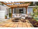 Close-up of a charming patio with comfortable seating and a decorative pergola, perfect for relaxation at 4527 24Th S Ave, St Petersburg, FL 33711