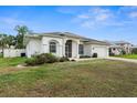 Inviting home featuring an attached two-car garage and complemented by lush landscaping at 4538 Appleton Ter, North Port, FL 34286