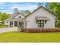 Stylish exterior showcasing modern trim, awning and easy to maintain landscaping at 4581 Majestic Hills Loop, Brooksville, FL 34601