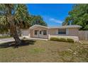 A single-story home featuring a well-maintained yard and light brick facade at 4619 Irene Loop, New Port Richey, FL 34652