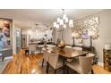 Elegant dining room with a chandelier, seating for six, and hardwood floors at 5010 Umber N Way, Tampa, FL 33624