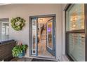 Inviting foyer with decorative glass door, staircase, and warm interior lighting at 5010 Umber N Way, Tampa, FL 33624