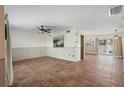 Spacious living room featuring tile floors and a sliding door offering natural light and access to the outdoor space at 6490 Cape Hatteras Ne Way # 4, St Petersburg, FL 33702