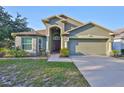 Attractive single-Gathering home with a large front yard and an attached two-car garage at 6933 Waterbrook Ct, Gibsonton, FL 33534