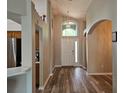 Elegant foyer with high ceilings, a decorative light fixture, and luxury vinyl plank flooring at 6933 Waterbrook Ct, Gibsonton, FL 33534