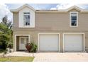 Two-story townhouse exterior showing the front door, two-car garage, and brick-paved driveway at 7647 Navigator Ct, Port Richey, FL 34668