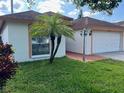 Charming single Gathering home with well manicured lawn and attached two car garage at 8908 Southbay Dr, Tampa, FL 33615