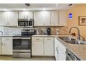 Efficient kitchen featuring stainless appliances, granite counters, and ample cabinet storage at 9450 Harbor Greens Way # 403, Seminole, FL 33776