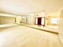 A bright living room features neutral carpet, a step-up platform, and a mirrored wall across from the front door at 10206 Lakeview Dr, New Port Richey, FL 34654
