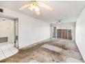 View of a dated living room featuring mirrored wall and sliding doors to balcony at 10215 Regal Dr # 21, Largo, FL 33774