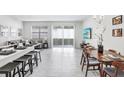 Bright, open-concept living area with access to patio, featuring modern tile floors, lots of natural light and stylish furniture at 11717 Blackbrook Ct, Seffner, FL 33584