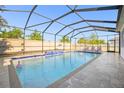 Inviting screened-in pool with a waterfall feature and plenty of room for lounging at 11854 Lake Lucaya Dr, Riverview, FL 33579