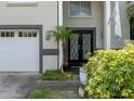 Close up on the double front doors with decorative glass and a two car garage at 1326 Moss Dr, Dunedin, FL 34698