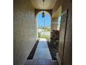 Inviting front entrance with a charming lantern and walkway leading to a beautifully landscaped yard at 14324 Bronte Ct, Hudson, FL 34667