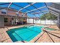 Screened pool and spa area with brick pavers and outdoor ceiling fans at 1751 Split Fork Dr, Oldsmar, FL 34677