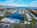 Panoramic aerial view features a waterfront community with canal access and a central pool area at 18675 Us Highway 19 N # 140, Clearwater, FL 33764