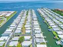 Wide aerial shot showcasing a community of waterfront homes with boat docks along canal waterways at 18675 Us Highway 19 N # 140, Clearwater, FL 33764