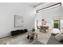 Open-concept living room with high ceilings, neutral decor, and tile floors that offers a modern and inviting atmosphere at 2070 Sunset Point Rd # 111, Clearwater, FL 33765