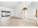 Bright living area with sliding glass doors to the patio, enhancing the indoor-outdoor flow and natural light at 2070 Sunset Point Rd # 111, Clearwater, FL 33765