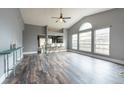 Spacious living room with vaulted ceilings, large windows, and modern wood-look flooring throughout at 2604 Shilo Ct, Valrico, FL 33596