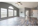 Bright living room featuring a decorative accent wall, large windows, and stylish hard surface flooring at 2604 Shilo Ct, Valrico, FL 33596