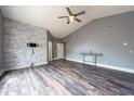 Open living space with vaulted ceilings, modern flooring, and a console table for versatile use at 2604 Shilo Ct, Valrico, FL 33596