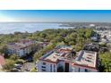 Aerial view shows condo building with view of bay and city at 2630 Pearce Dr # 104, Clearwater, FL 33764